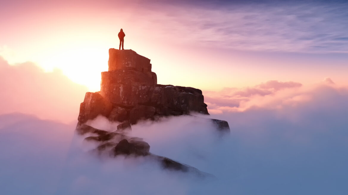 A man standing on a stone cliff